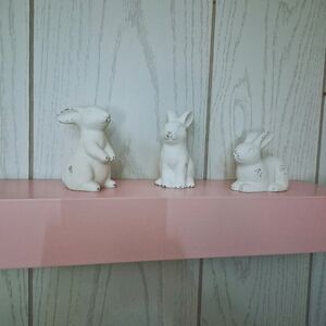 Pink Shelf And White Ceramic Bunny Figurines